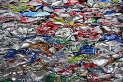Smashed, crushed, compressed aluminum beverage cans, scrap metal recycling.